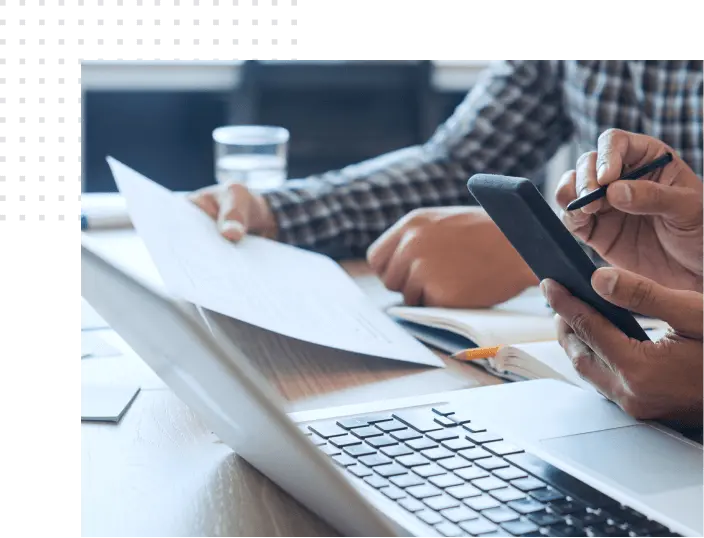 Office workers with a smartphone and a document working on a project, a laptop nearby